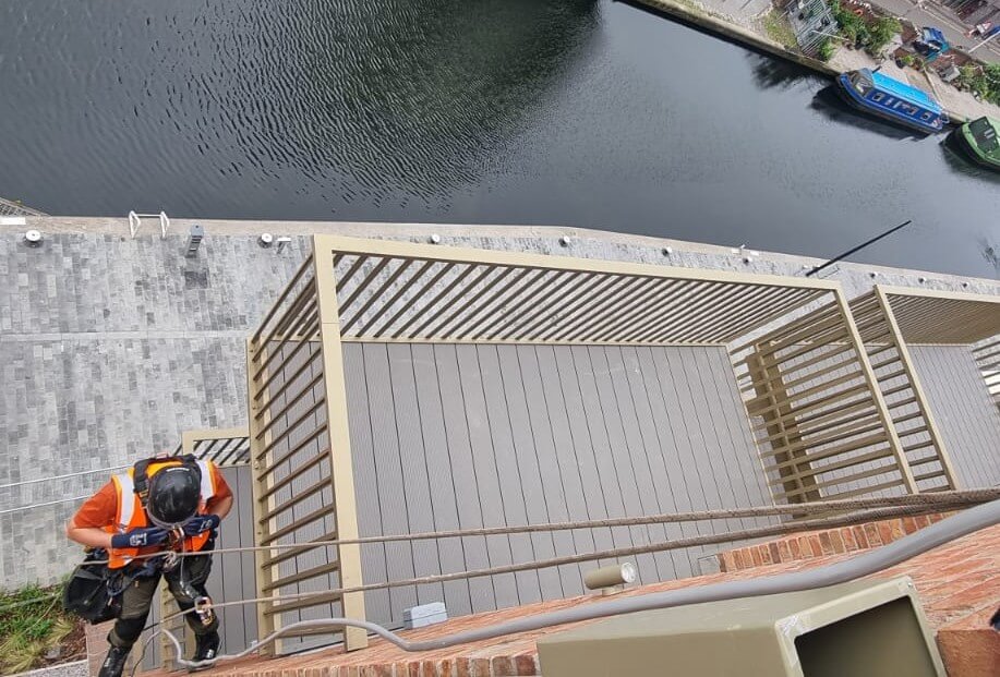 looking down at one of our rope access team as we install lightning protection system for a client in Edinburgh